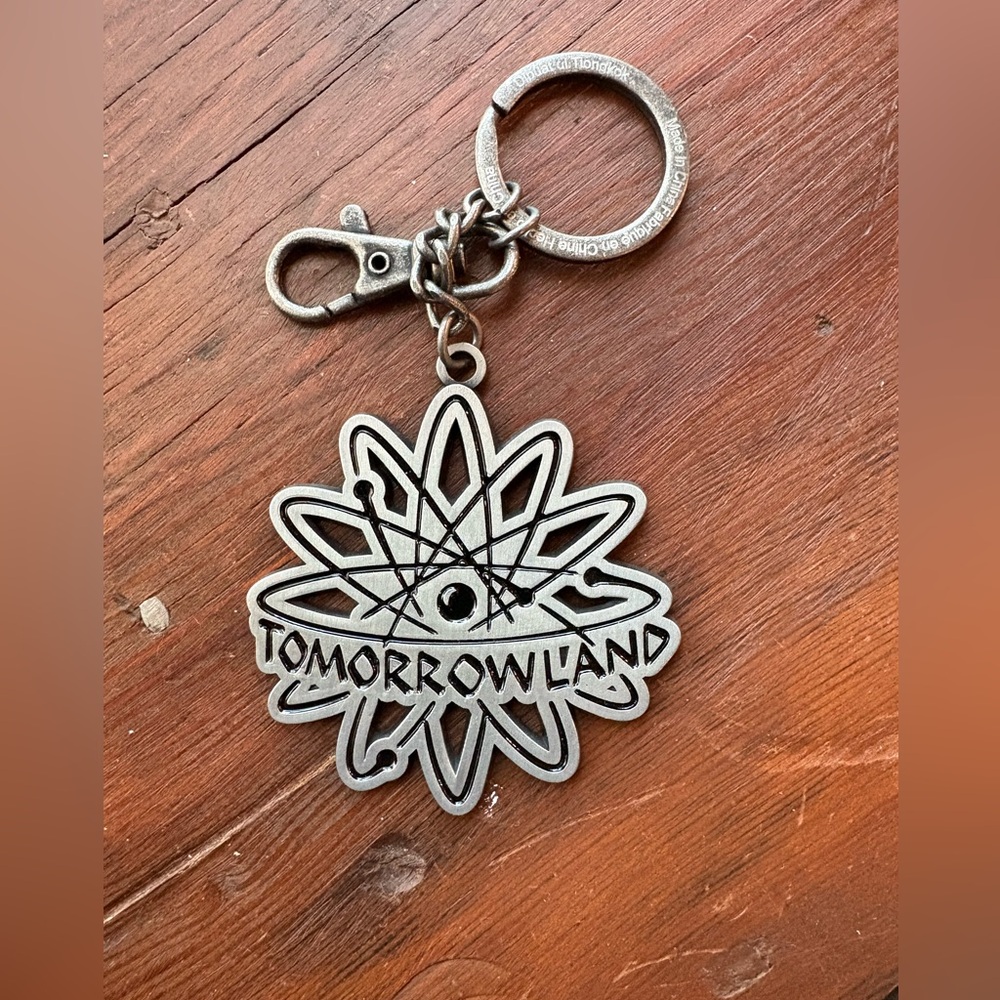 New never used Disney Tomorrowland metal keychain or bag charm.